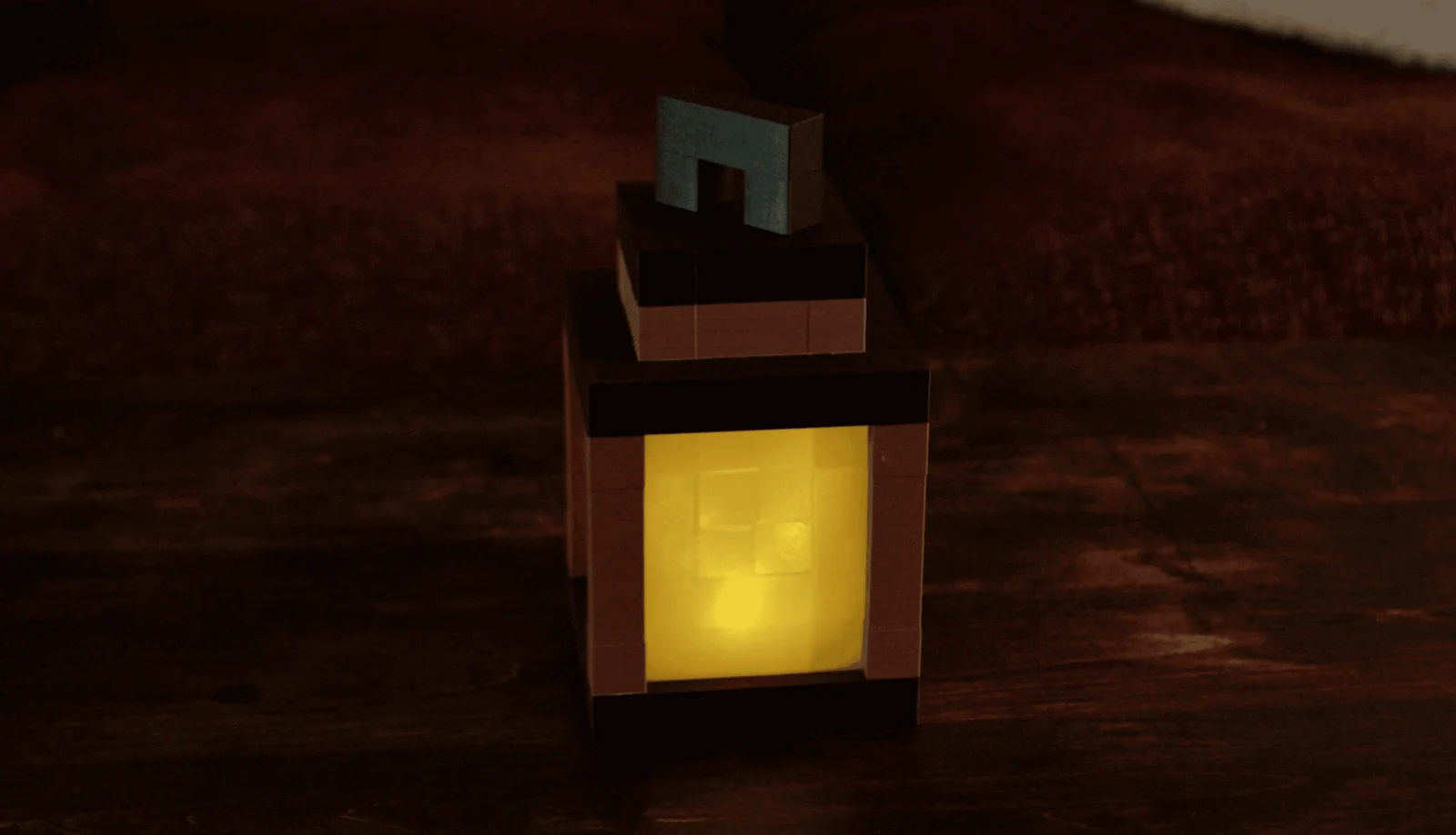 A 3D-printed Minecraft-themed lantern with a handle on top, glowing warm yellow through its translucent panel on a dark wooden table